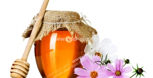 عکس با کیفیت شیشه عسل با قاشق مخصوص عسل در کنار گل های سوسنی رنگ آستر