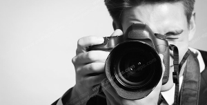 عکس با کیفیت سیاه و سفید عکاس حرفه ای در حال گرفتن عکس با دوربین حرفه ای