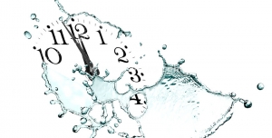 عکس با کیفیت تبلیغاتی ساعت بدون صفحه دلارای عقربه و اعداد که آب اطراف آن را گرفته است